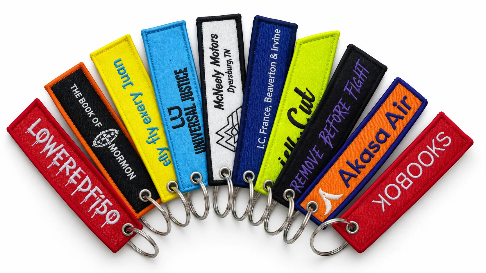 Gallery of custom fabric keychains in varied colors and artwork styles